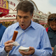 Politician Rick Perry eats corn dog at Iowa State Fair